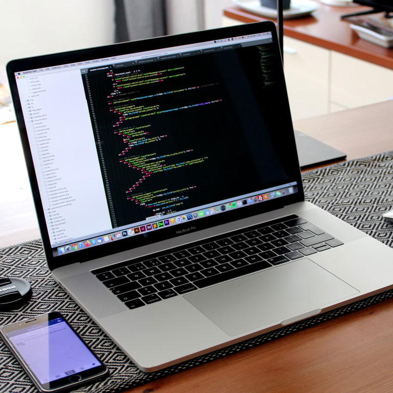 A young professional woman pointing at a visual presentation in a bright office, engaged in a strategic discussion.